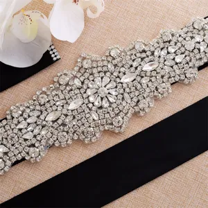 Detailed view of the sparkling silver rhinestone bridal belt with black ribbon ornament.