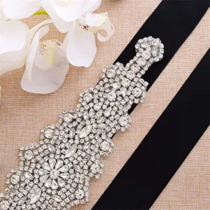 Silver rhinestone bridal belt detail shot, sparkling crystal sash wedding dress accessory.