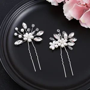 Detail shot of elegant bridal hair pin set with sparkling crystals and faux pearls.