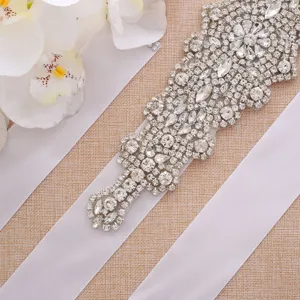 Elegant bridal rhinestone belt with sparkling crystals and white satin ribbon for wedding dress.