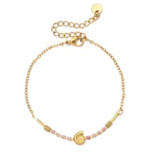 Minimalist stainless steel bracelet with natural pink stone and cute spiral shell charm detail.
