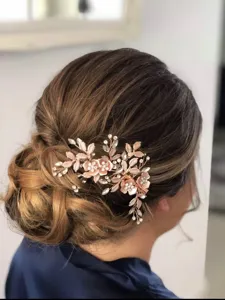 Exquisite rose flower bridal hair comb with shimmering rhinestones and delicate leaf updo design.