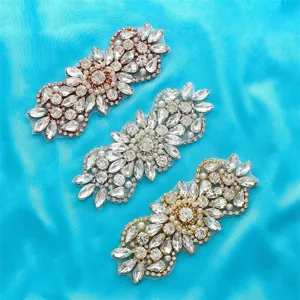 Detailed close-up of crystal rhinestone applique patch, sparkle floral design for dress sash.