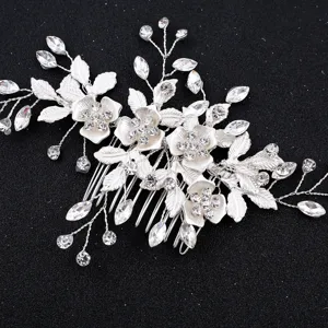 Exquisite silver bridal hair comb with floral crystal and leaf design for elegant wedding hairstyles.