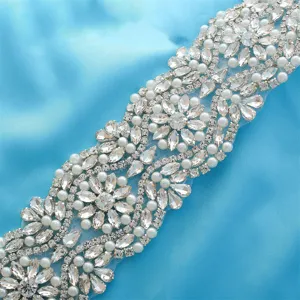 Close-up detail of sparkling rhinestone pearl bridal belt appliqué, exquisite craftsmanship.