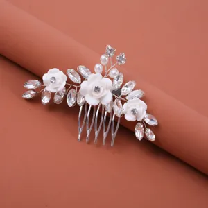 Bridal rhinestone hair comb detail close-up showcasing white floral crystal beaded wedding hair piece.