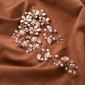 Detailed view of the gold bridal hair vine showcasing delicate metallic flowers and pearls.