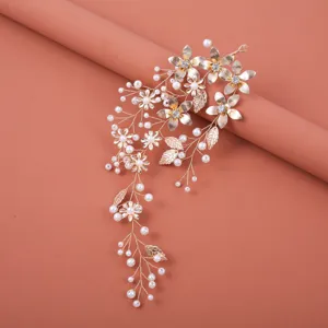 Gold bridal hair vine with pearls and metal flowers, elegant hair accessory for wedding.