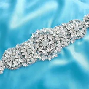 Exquisite rhinestone pearl bridal belt applique detail, sparkling wedding dress accessory.