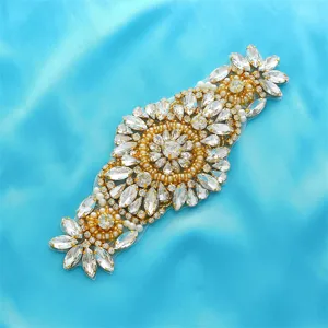 Close-up detail of sparkling rhinestone applique for wedding dress waistband and bridal belt decor.