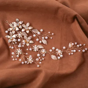 Gold bridal hair vine with pearls and leaves, elegant wedding hair accessory for women.