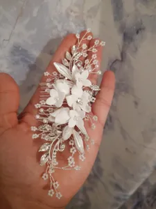 Handgemachter Braut Haarkamm mit weißen Keramikblüten, silbernen Blättern und schönen Kristallen.