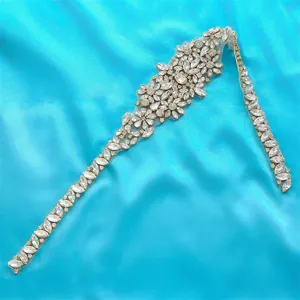 Bridal rhinestone sash applique detail, sparkling crystal wedding dress belt close-up.