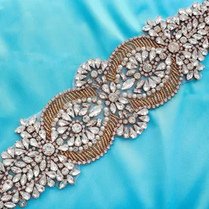 Stunning crystal bridal belt applique close-up, sparkling rhinestone wedding dress sash trim.