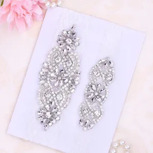 Elegant rhinestone bridal garter applique set featuring sparkling crystals and pearls.