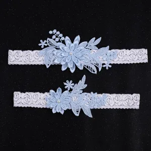 Light blue lace beaded bridal garter set with elastic floral embroidery for wedding.