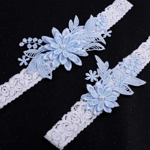 Elegant blue lace wedding garter set with pearls, perfect bridal accessory for your special day.