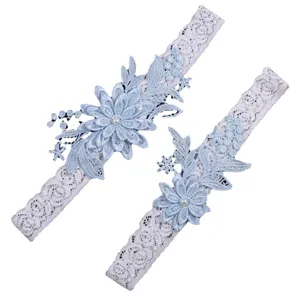 Elegant light blue lace wedding garter set with floral embroidery and pearl accents for brides.