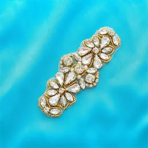 Detailed shot of rhinestones and pearls on a floral applique, perfect for bridal gown embellishment.