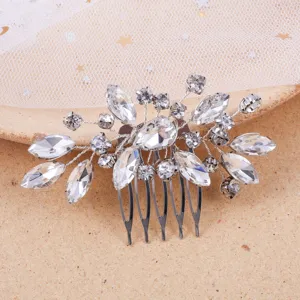 Detailed close-up shot of silver rhinestone bridal hair comb, sparkly crystal wedding hair accessory.