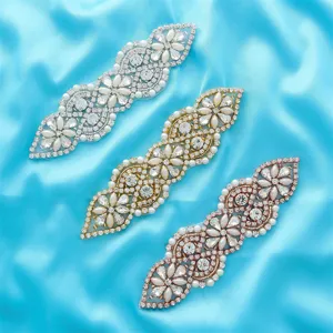 Detail shot of crystal pearl rhinestone appliques for bridal wedding dress belts and sashes.
