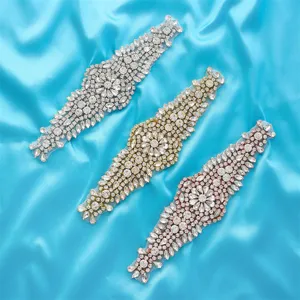 Close-up of sparkling rhinestone applique, detailed crystal embellishment for bridal dress.