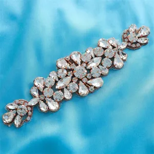 Close-up detail of exquisite rhinestone appliqué accessory for bridal belt and evening dress.