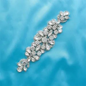 Exquisite rhinestone appliqué detail view, sparkling crystals on net for bridal belt accessory.