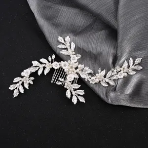 Bridal hair comb detail shot featuring handmade crystal rhinestones, pearls and ceramic flowers.