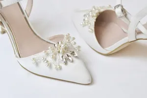 Elegant white bridal high heels detail featuring handmade pearl and crystal rhinestone toe clips.