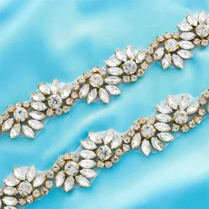 Close-up detail of sparkling rhinestone crystal trim applique for bridal wedding dress belt design.