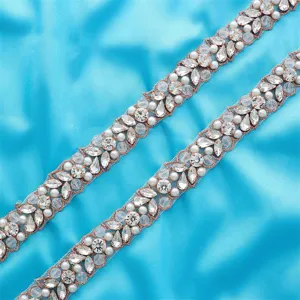 Detailed view of sparkling rhinestone pearl bridal belt trim wedding dress decorative accessory.