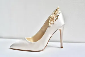 Elegant white satin high heels with pearl rhinestone floral applique for bridal wedding wear.