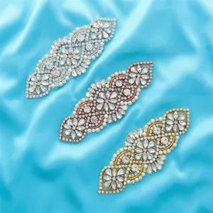 Close up view of crystal rhinestone applique patches in silver, rose gold, and gold colors.