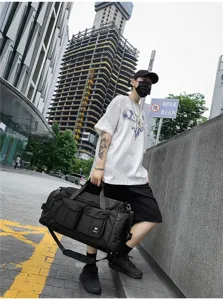 Black large capacity travel duffel bag with shoulder strap, durable gym sports bag.