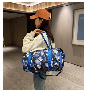 Stylish blue duffel gym bag with cute cartoon pattern, ideal for sports, travel, and swimming.