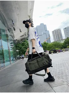 Large capacity travel duffel bag with multiple pockets, durable green canvas gym bag for men.