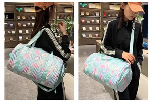 Small quilted fitness duffel bag with colorful cartoon pattern, mint green straps for travel.
