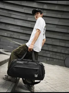 Detailed view of the large capacity black travel duffel bag showing durable fabric and sturdy handles.