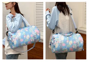 Detailed view of colorful unicorn print cylindrical sports duffel bag for gym and travel use.