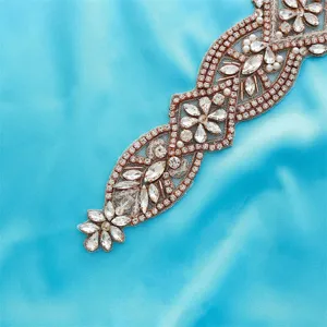 Close-up detail of luxury bridal rhinestone applique with sparkling clear crystals and pearls.