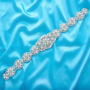 Detailed view of silver bridal rhinestone applique with sparkling crystals and pearls.