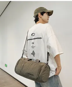 Detailed view of a khaki lightweight travel duffel bag with shoulder strap and front zip pocket.
