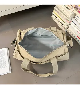 Detail shot of the lightweight beige travel duffel bag, showing spacious interior and durable fabric.