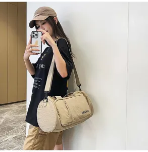 Casual large capacity travel duffel bag for women, waterproof gym shoulder bag with multiple pockets.
