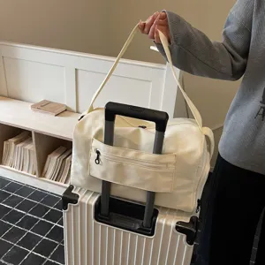 Detail view of large capacity travel duffel bag with trolley sleeve and zipper pocket.