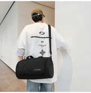 Detail view of the black travel duffel gym bag with shoulder strap and front pocket display.