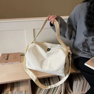 Canvas travel duffel bag for women, large capacity gym sports bag with comfortable shoulder strap.