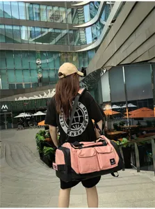 Scene detail view of large capacity pink black travel duffel bag with multi pockets outdoor.