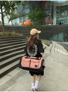 Large capacity travel duffel bag in pink and black color, ideal for gym, sports and weekend trips.